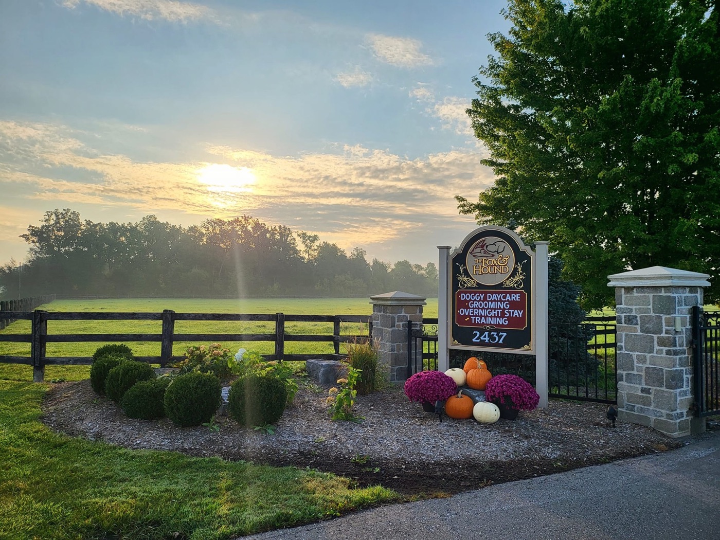 The Fox & Hound sign at 2437 Michigan Line, with the fields behind it at sunrise