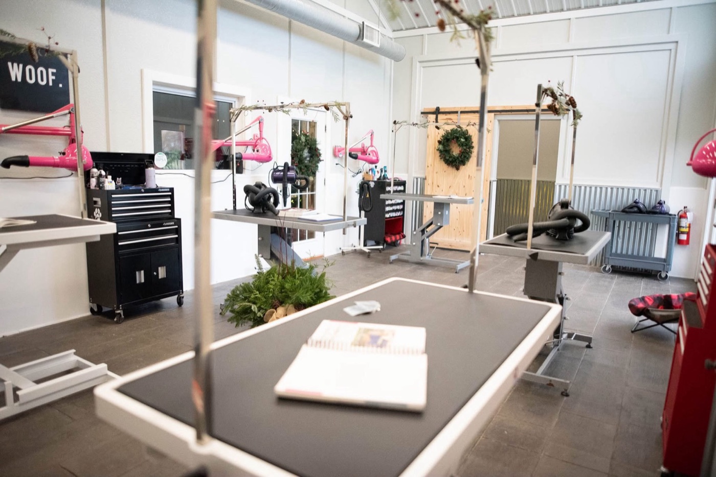 The F&H grooming salon with grooming tables, wreaths and garland