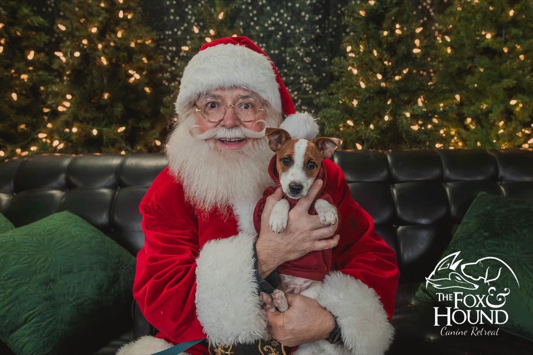 Santa hugging a dog at the F&H